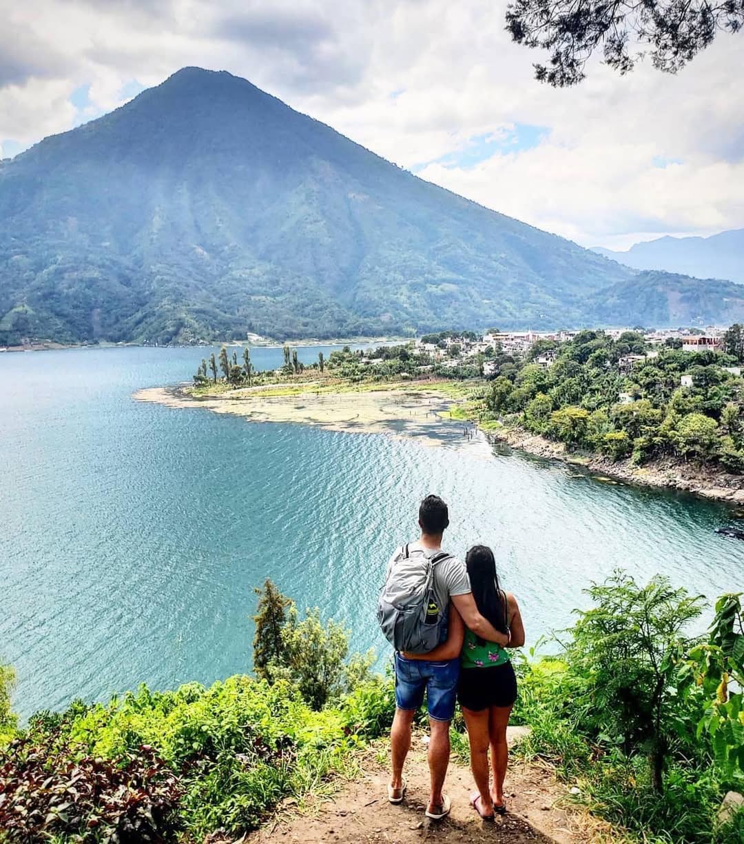 Couple overlooking Lake Atitlán and Santiago Atitlán from a scenic viewpoint