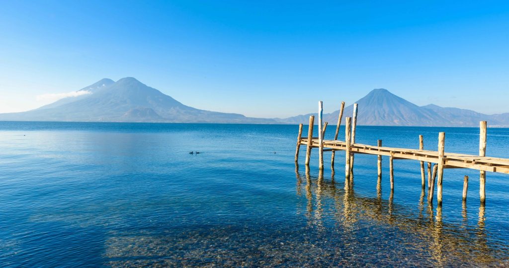 Wooden dock in Panajachel overlooking Lake Atitlán and volcanoes in Guatemala