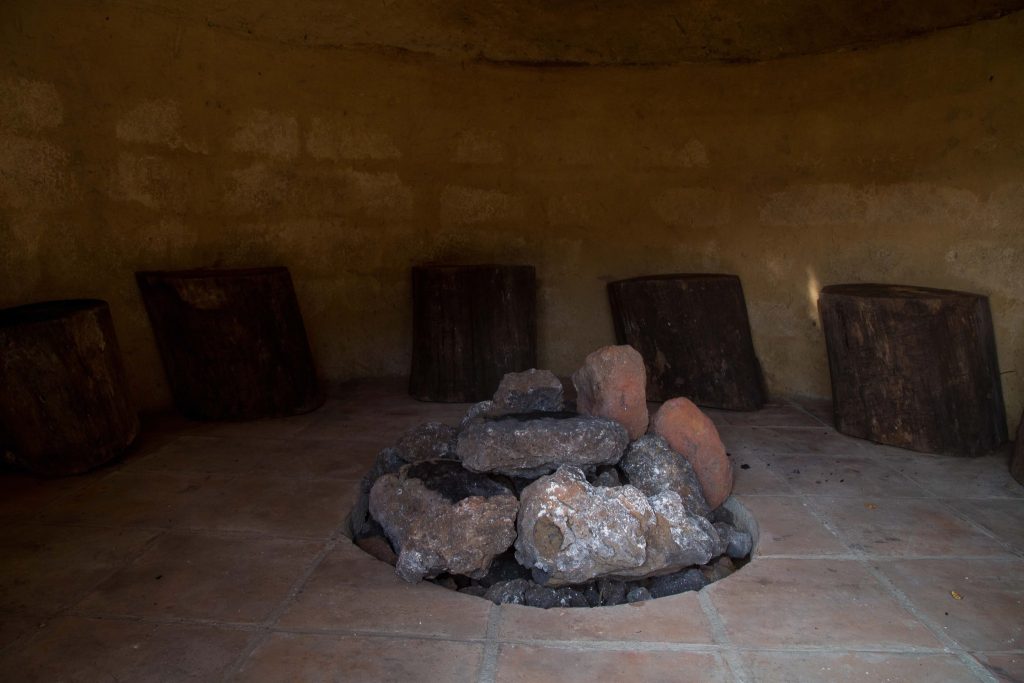 Interior of a traditional Guatemalan temazcal with heated volcanic stones
