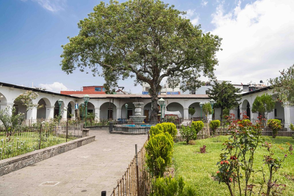 Courtyard of the Church of Saint James the Apostle in Santiago Atitlán Sololá Guatemala with a giant ceiba tree