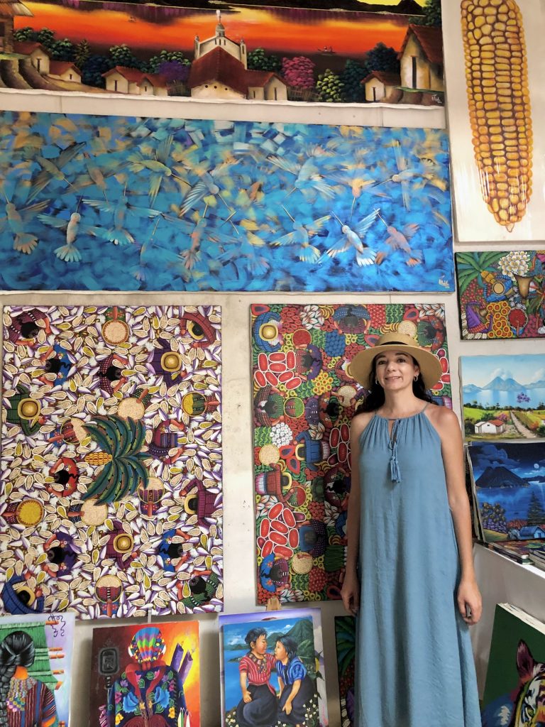 Exploring local artwork and handmade paintings in one of San Marcos La Laguna's colorful art spaces.