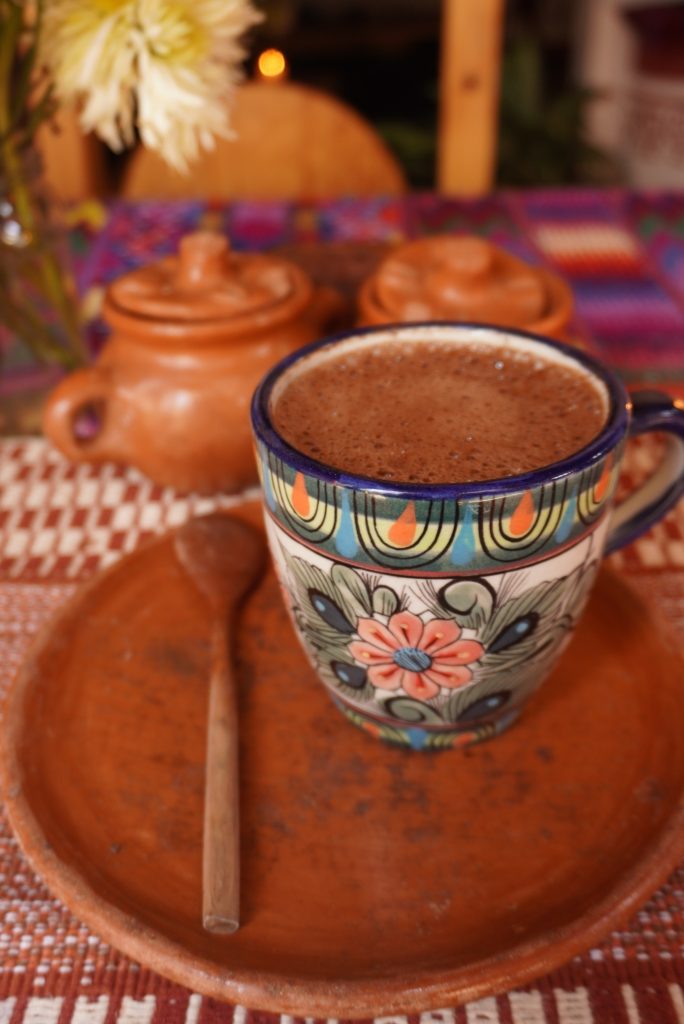 Traditional hot cacao drink served in handcrafted Guatemalan pottery during a cacao ceremony in Guatemala