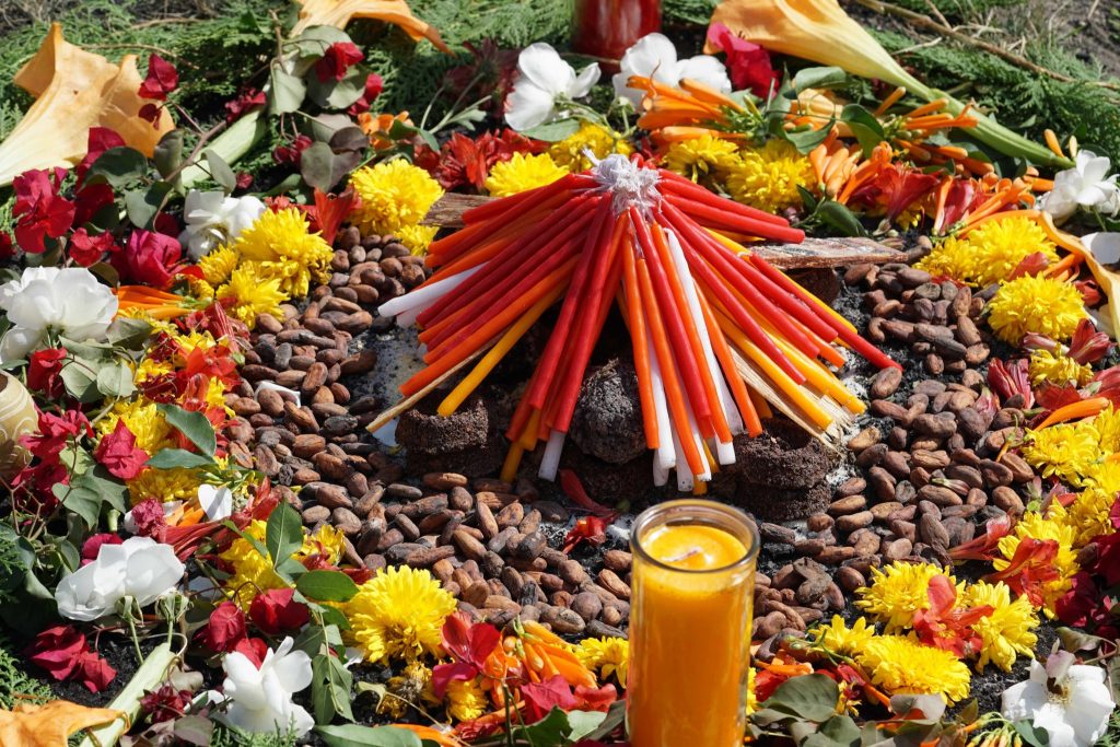 Ceremonial cacao altar with cacao beans, flowers, and candles in Guatemala
