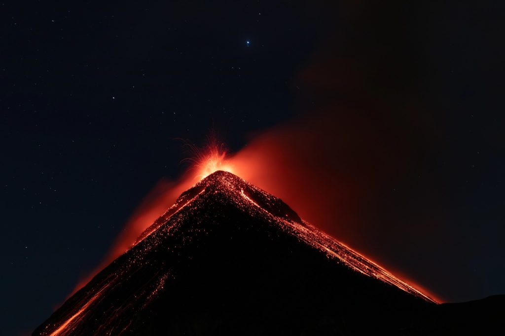 Fuego volcano erupting with glowing lava at night as seen from Acatenango base camp