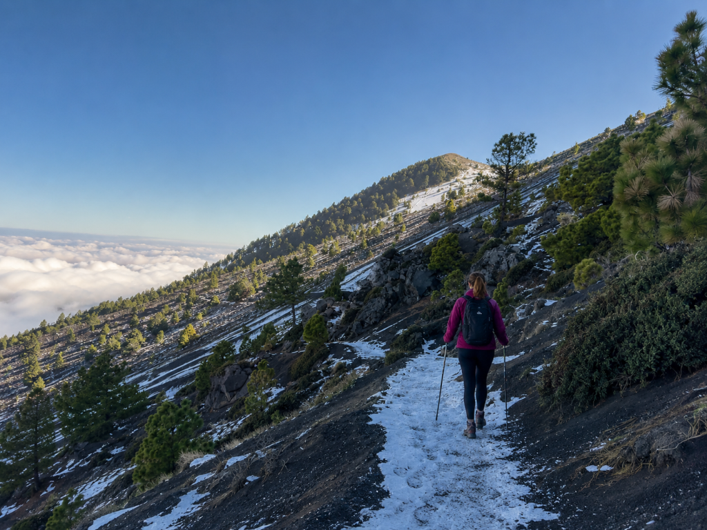 Hiker walking through unexpected snow on the Acatenango volcano trail