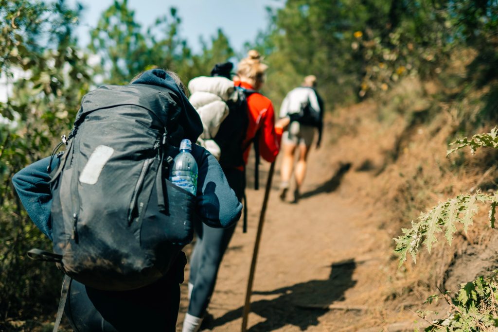 Hikers climbing a steep uphill section of the Acatenango volcano trail in Guatemala