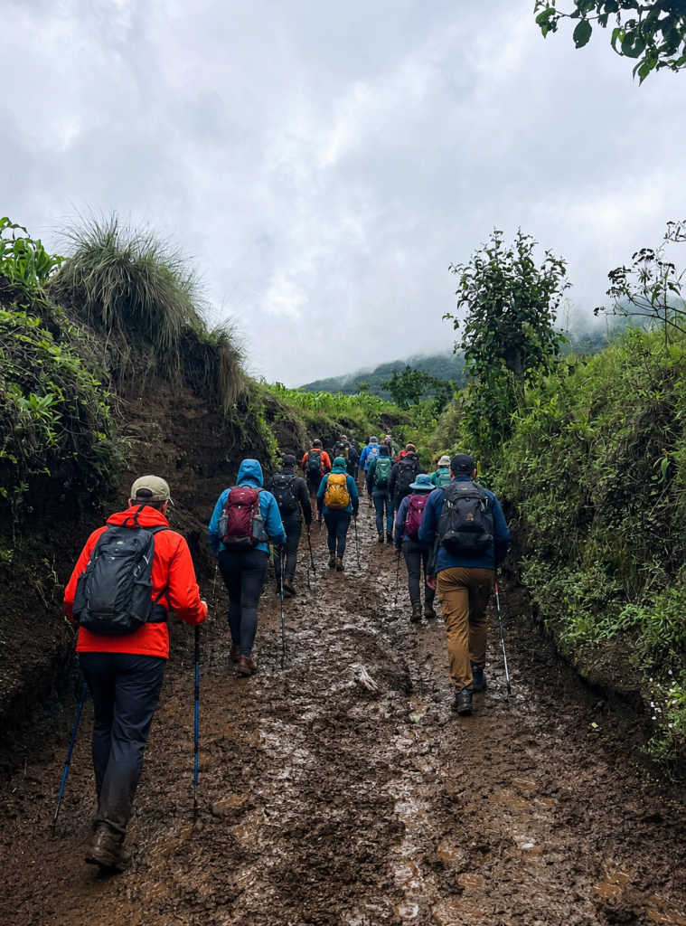 Group of hikers walking through a muddy trail on the Acatenango volcano hike