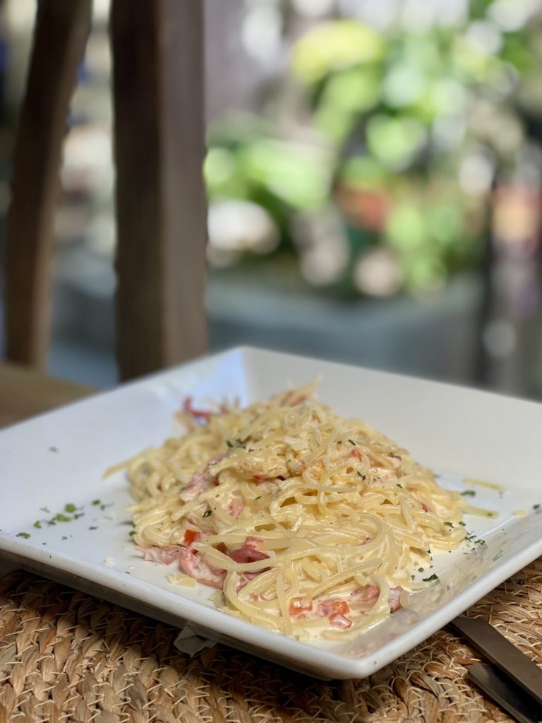 Gluten-free spaghetti in a creamy sauce with prosciutto and grated cheese at Pasta Nostra in Antigua Guatemala.