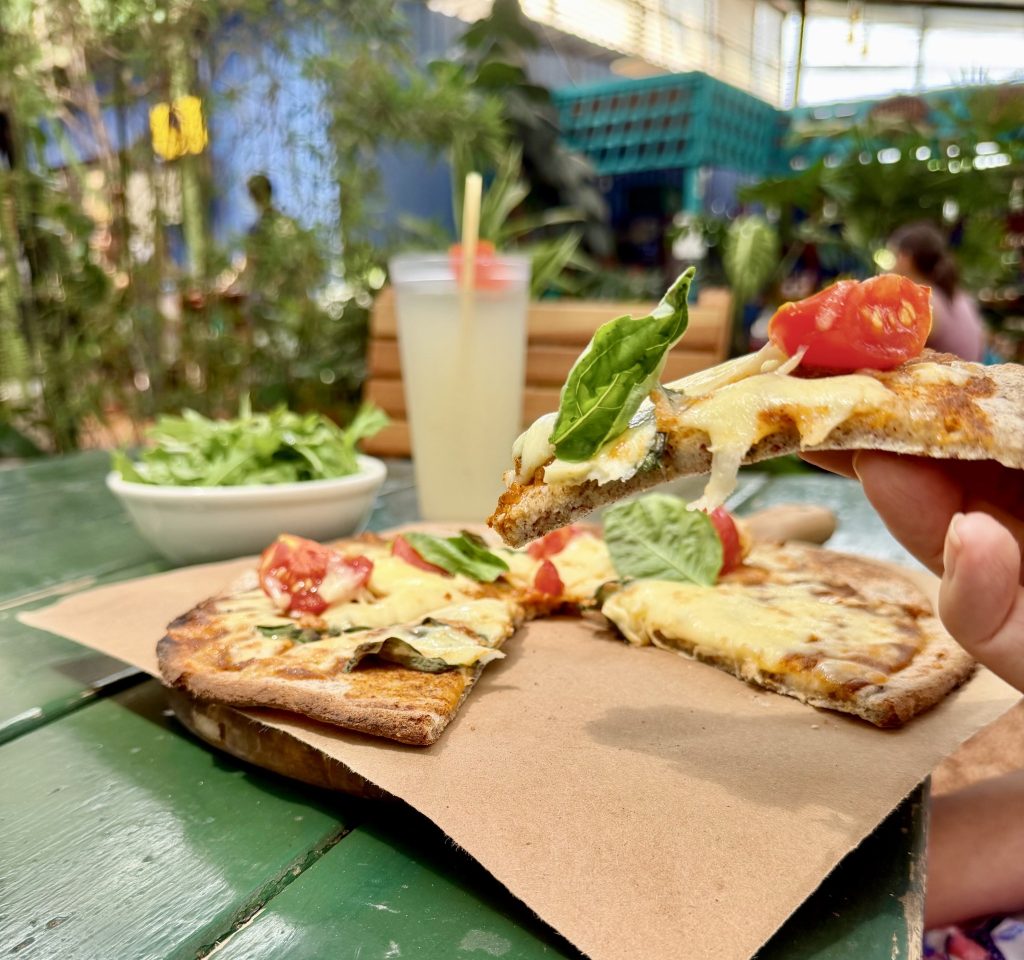 Gluten-free pizza slice with tomato and basil at Caoba Farms Antigua Guatemala