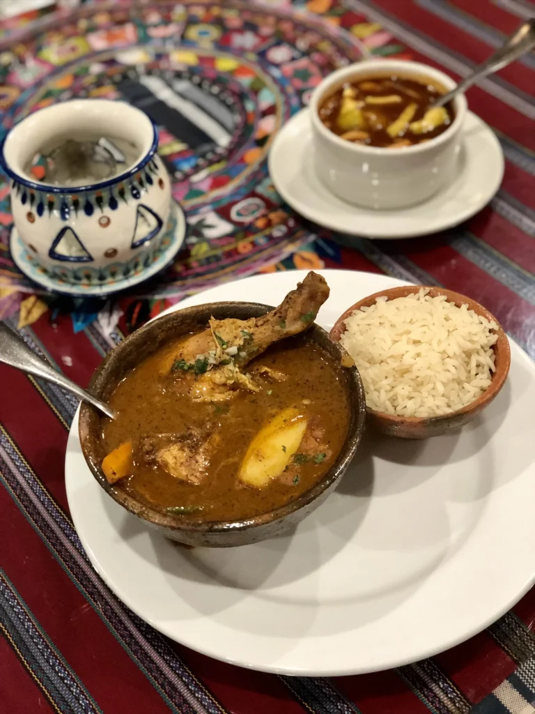 Guatemalan chicken pepián with rice served at Porta Hotel del Lago restaurant in Panajachel