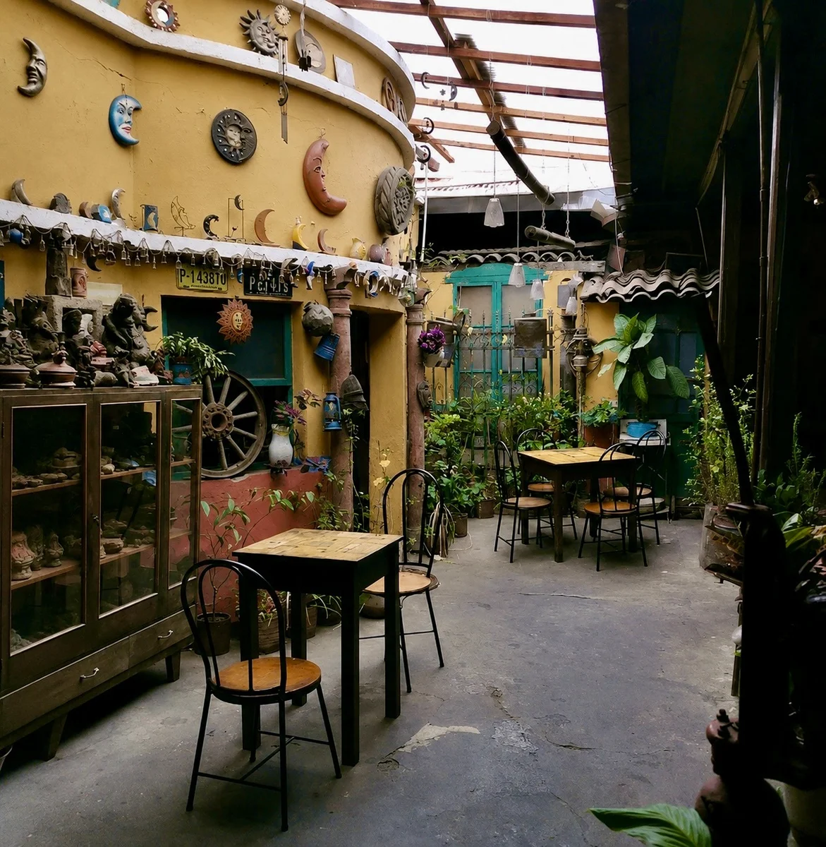 Courtyard of Café La Luna in Xela decorated with antiques and moon art