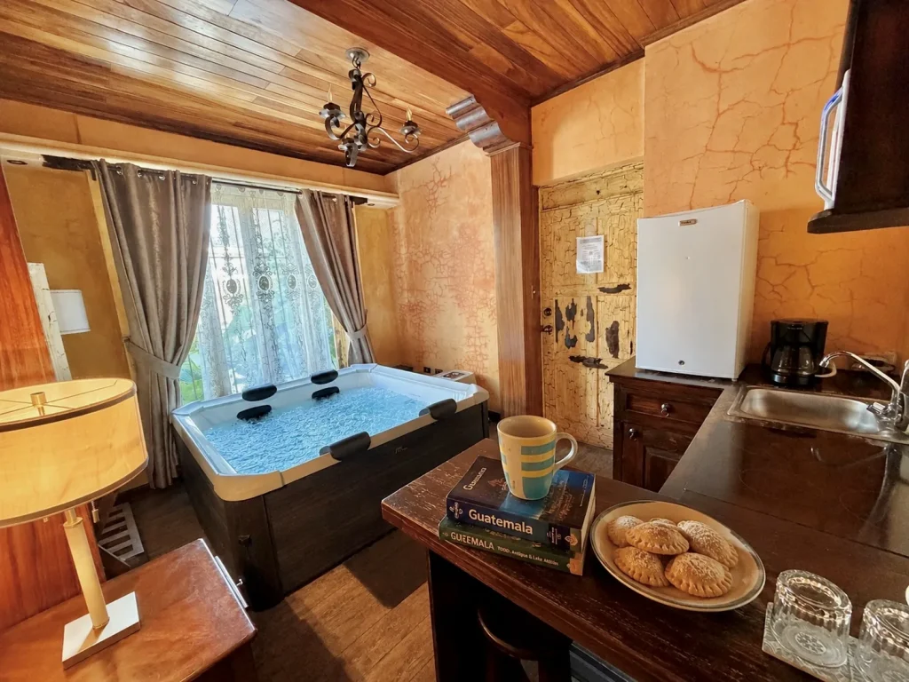 Private indoor jacuzzi and small kitchenette inside a suite at Hotel Casa Realeza in Antigua Guatemala.