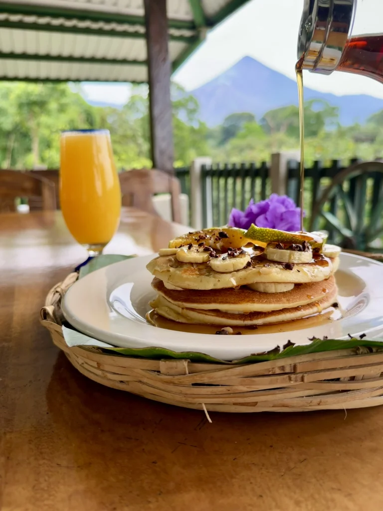 Banana pancakes served at Reserva Patrocinio with Santiaguito and Santa María volcanoes visible from the open-air restaurant