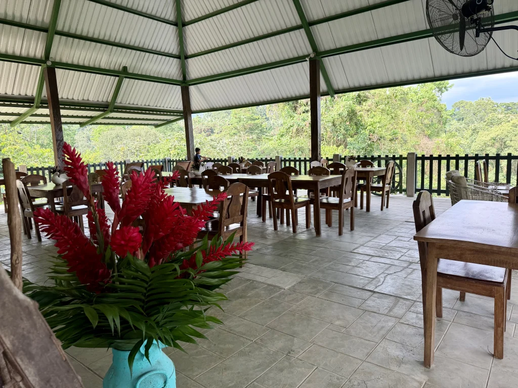 Open-air Cafetería El Mirador restaurant surrounded by tropical forest at Reserva Patrocinio Guatemala