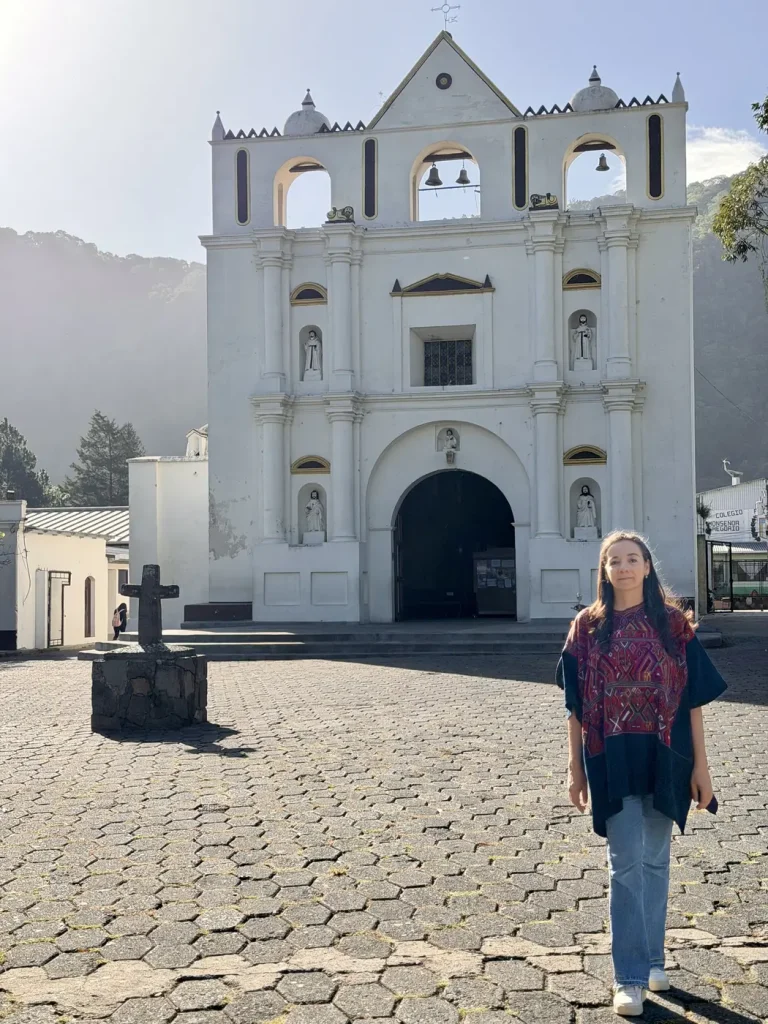 Catholic church in the center of San Lucas Tolimán Guatemala with mountains behind it